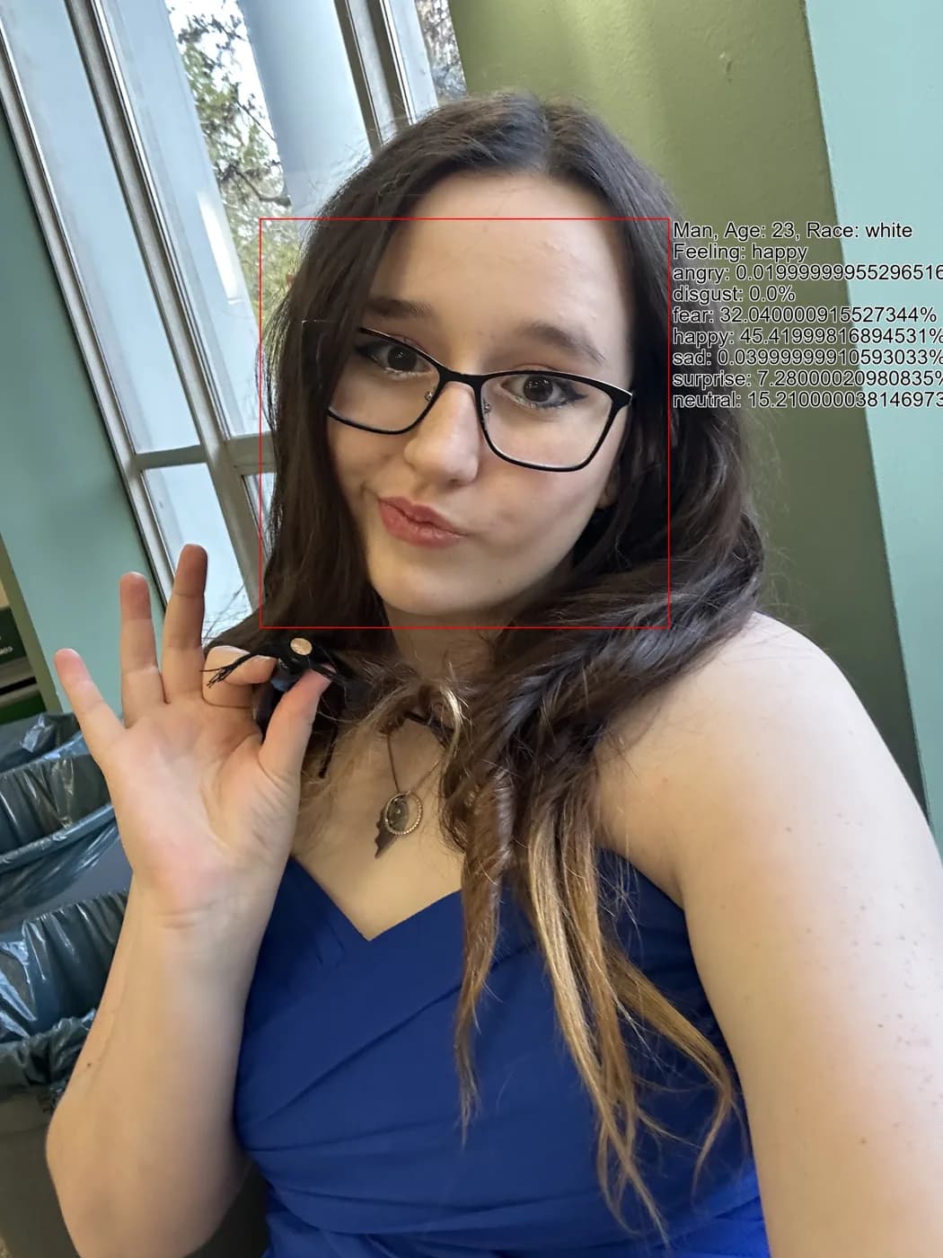 A selfie overlaid with AI analysis boxes reading the subject as a man