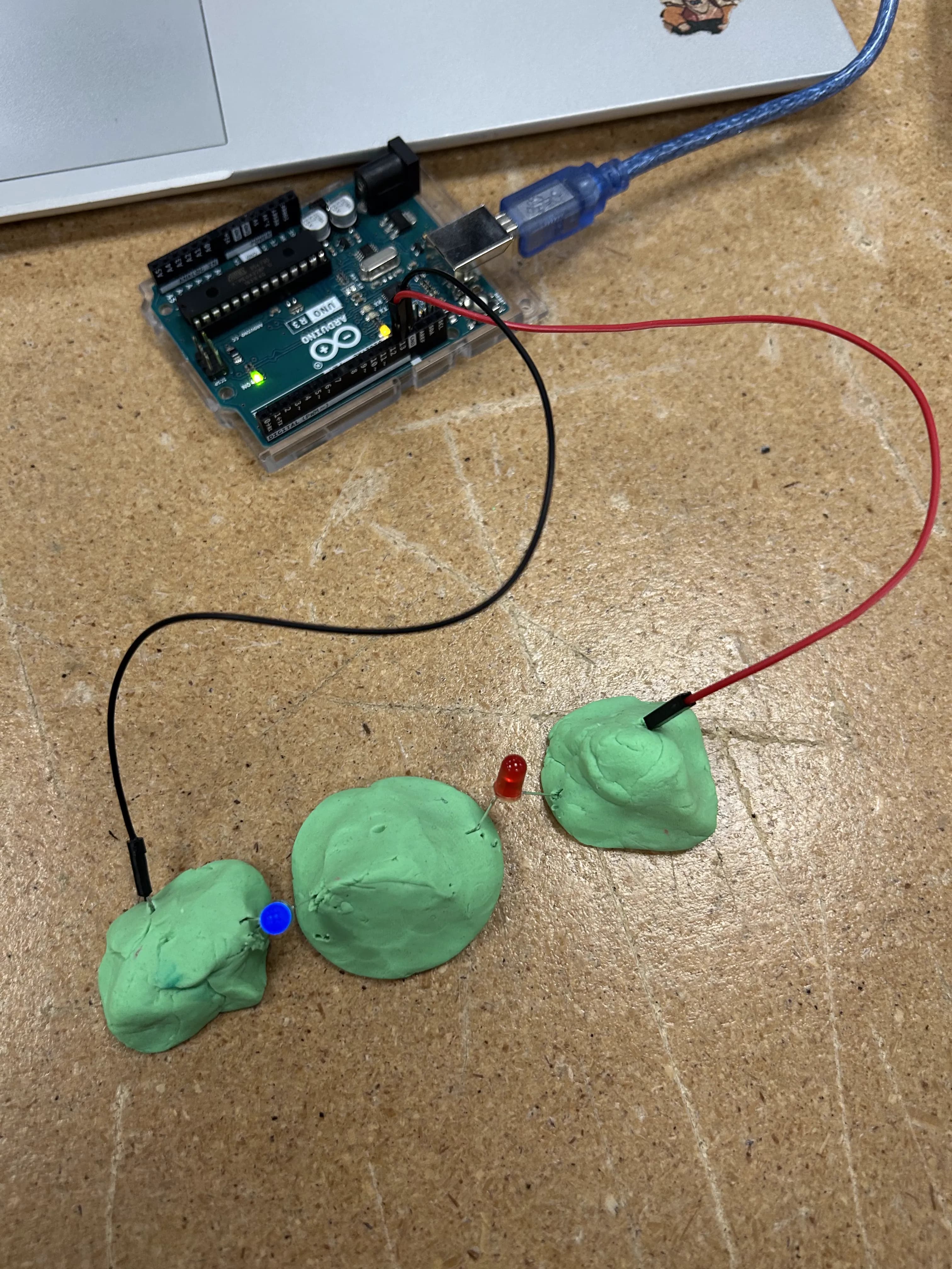 An Arduino wired to Play-Doh circuits with LEDs